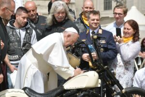 Pope Francis signs a custom harley motorcycle